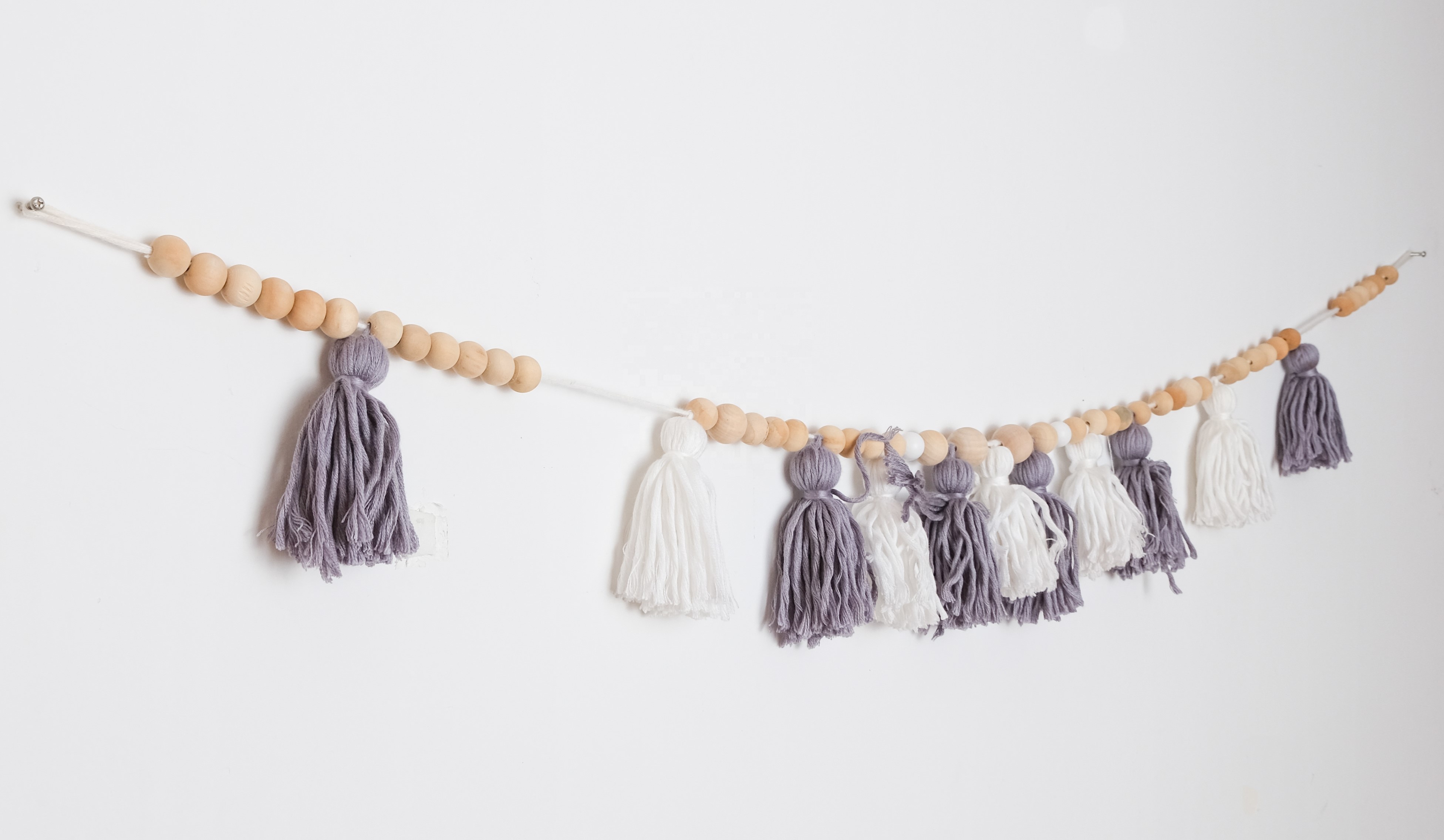purple and white tassle beaded bunting wall decor